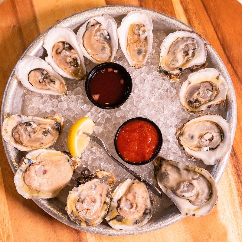 Raw oyster platter with cocktail sauce and lemon at Big Fish Grill